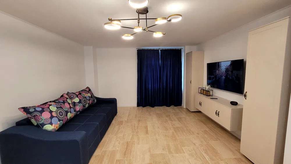 A living room with a couch and a television