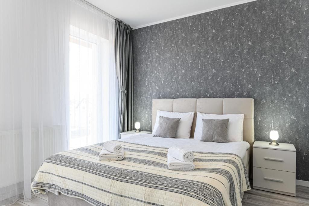 Una camera con letto e finestra — appartamento a Brașov