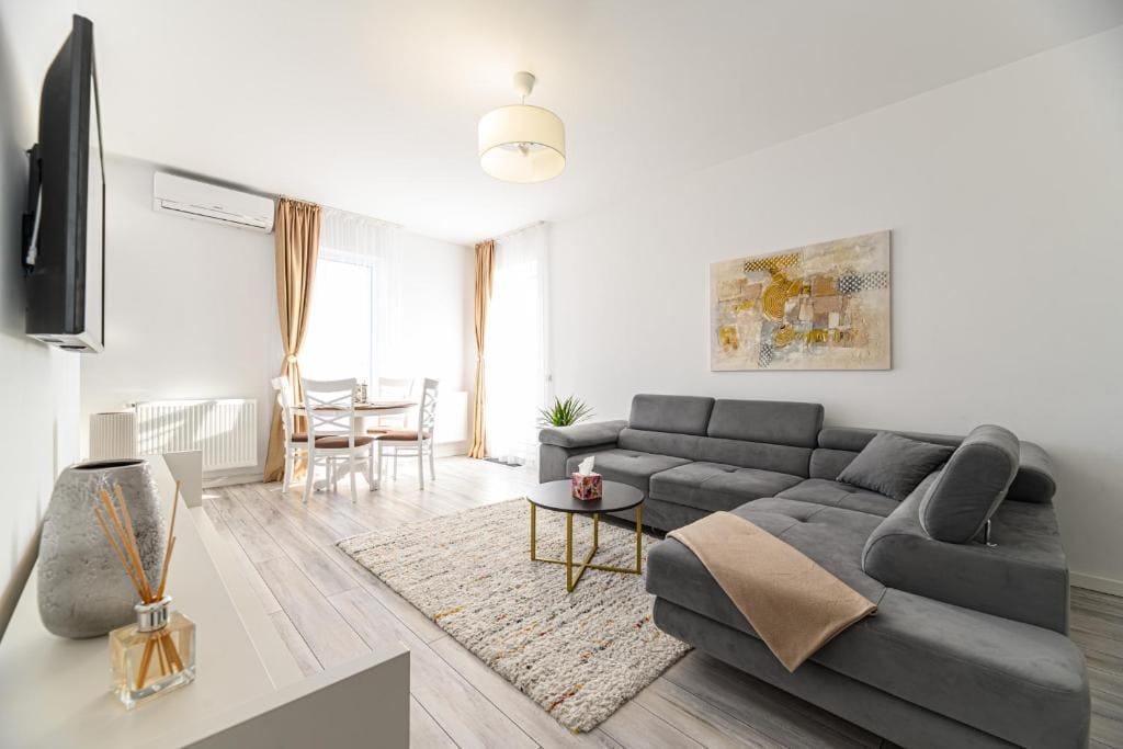 Un soggiorno con divano, tavolo e sedia — appartamento a Brașov