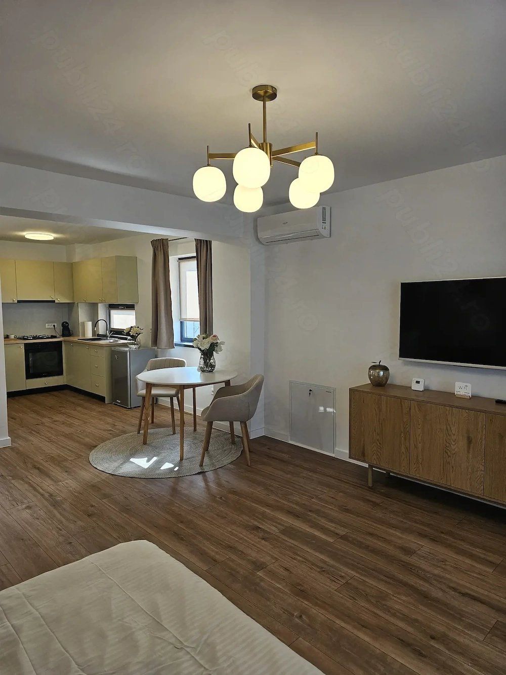 A living room with a table, chairs, and a TV